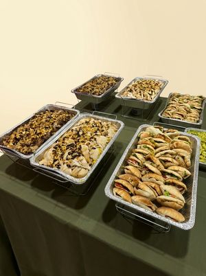 Catering spread of Bayte Bites dishes laid out on a buffet table for an event