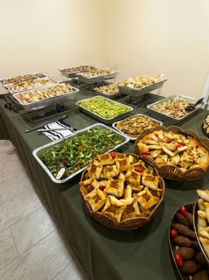 A second catering table set up with trays of Lebanese food for a Bayte Bites catered event