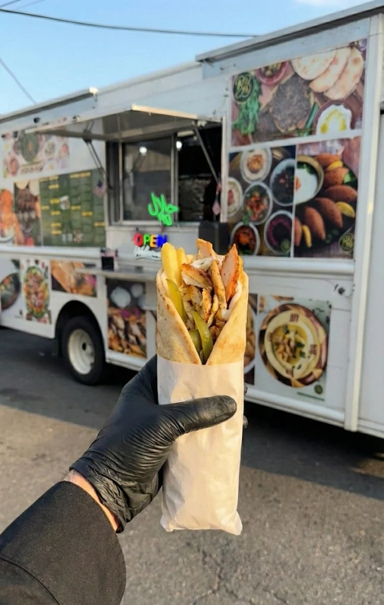 Chicken shawarma being carved fresh at the Bayte Bites truck window