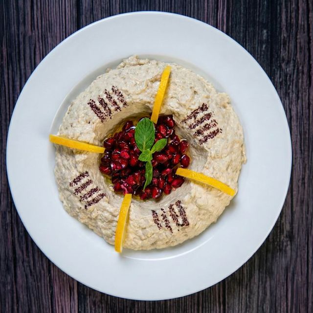 Smoky moutabal eggplant dip topped with pomegranate seeds and olive oil